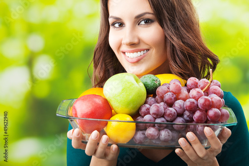 Photo: Woman with plate of fruits, outdoors Woman with plate of fruits, outdoors