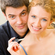 Photo: Cheerful couple or young family with key Cheerful couple or young family with key