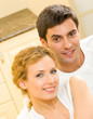 Cheerful smiling young couple, indoors
