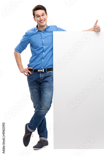 Photo: Man with blank poster showing thumbs up Man with blank poster showing thumbs up