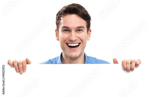 Photo: Man peeping over blank poster Man peeping over blank poster