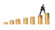 Businessman goes up the gold coins