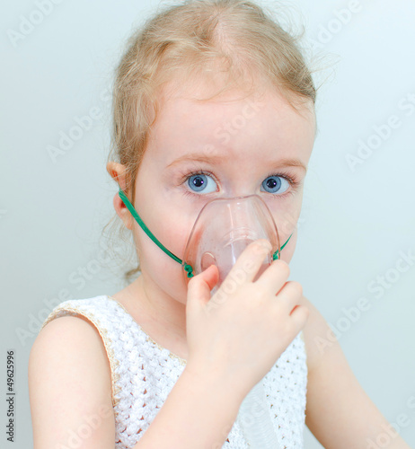Photo: Portrait of little girl with inhalator mask on the face Portrait of little girl with inhalator mask on the face