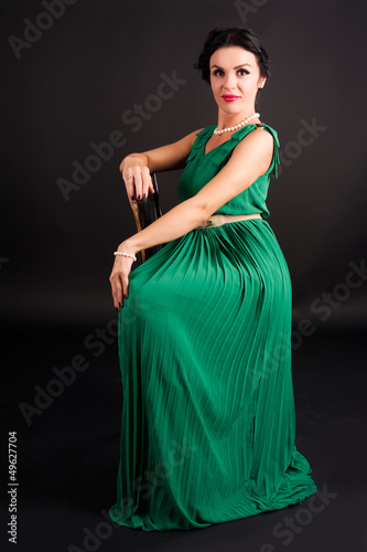 Photo: pretty young woman sitting on chair pretty young woman sitting on chair