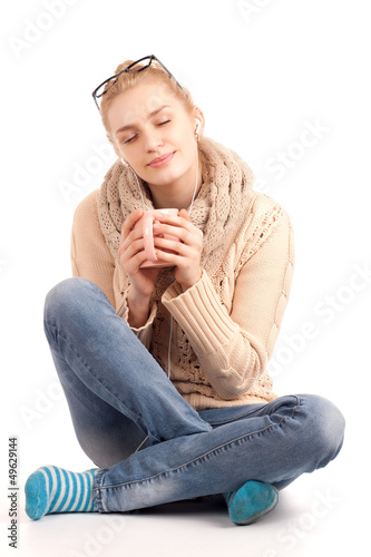 Photo: Blond woman holding cup of hot drink Blond woman holding cup of hot drink