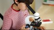 Young boy with microscope
