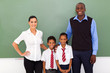 group of primary school teachers and students in classroom