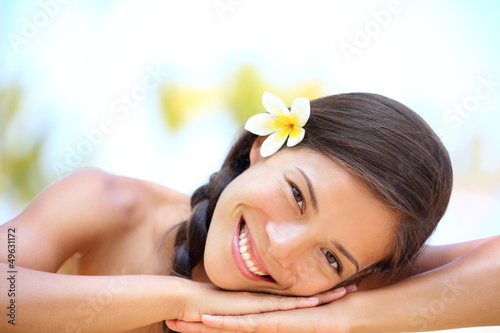 Photo: Woman natural beauty relaxing at outdoor spa Woman natural beauty relaxing at outdoor spa