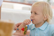 Little blond boy in a cafe