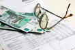 russian money and old spectacles to rest upon payment document