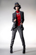 Photo: Full length fashion girl in hat posing on light background Full length fashion girl in hat posing on light background
