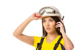 Serious female construction worker talking with a walkie talkie