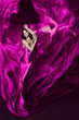 Photo: Woman in violet waving silk dress. Dancing. Woman in violet waving silk dress. Dancing.