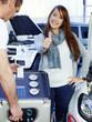 Customer in garage shows thumb up for good service