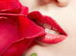 young woman biting rose