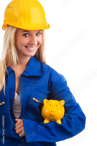 Photo: Female engineer with piggy bank Female engineer with piggy bank