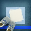 Photo: Blank card with baby shoes on blue background Blank card with baby shoes on blue background