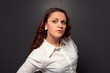 studio shot of curly woman looking at camera