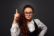 Photo: young woman in glasses showing attention sign young woman in glasses showing attention sign