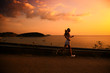 Young woman running at sunset