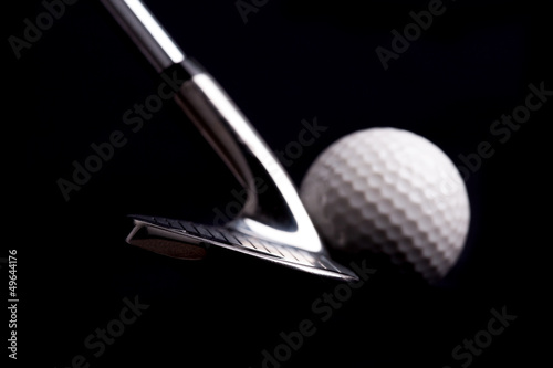Photo: golf club with ball on black background golf club with ball on black background