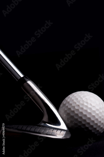 Photo: golf club with ball on black background golf club with ball on black background