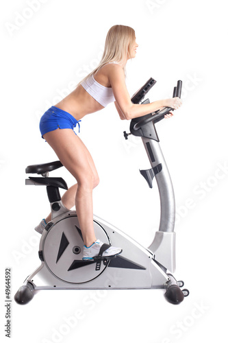 Photo: Athletic blonde training on bike exerciser Athletic blonde training on bike exerciser