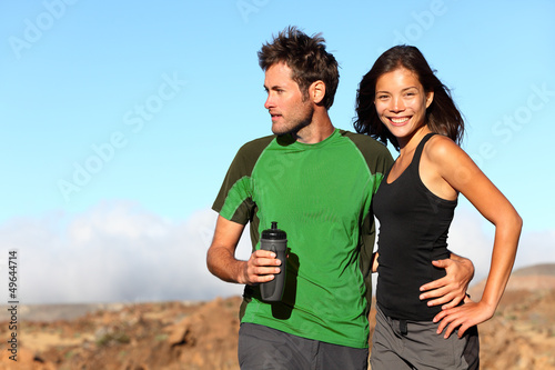 Photo: Young multicultural healthy couple in outdoor adventure Young multicultural healthy couple in outdoor adventure