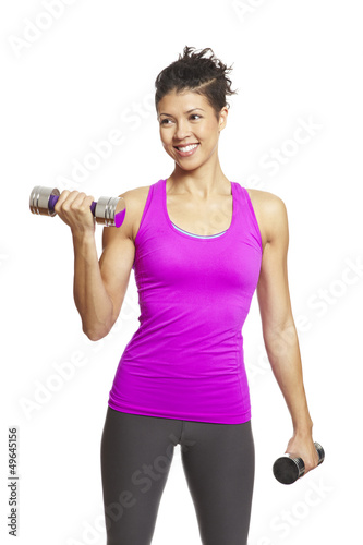 Photo: Young woman exercising holding dumbbells Young woman exercising holding dumbbells