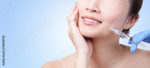 Photo: Cosmetic injection in the female lips Cosmetic injection in the female lips