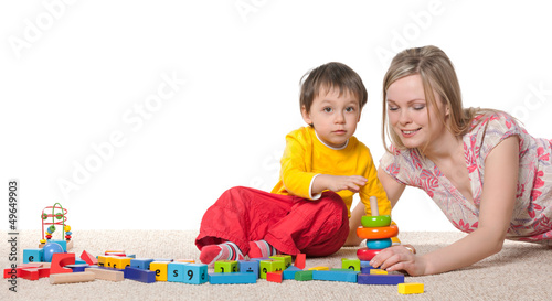 Photo: Mother and son on the carpet with toys Mother and son on the carpet with toys