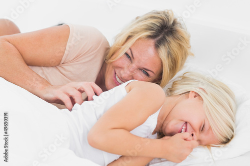 Photo: Mother tickling her daughter Mother tickling her daughter