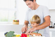 Father and son preparing vegetables together