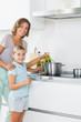 Happy mother and daughter cooking together