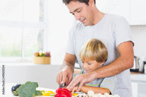 Photo: Father and son preparing vegetables together Father and son preparing vegetables together