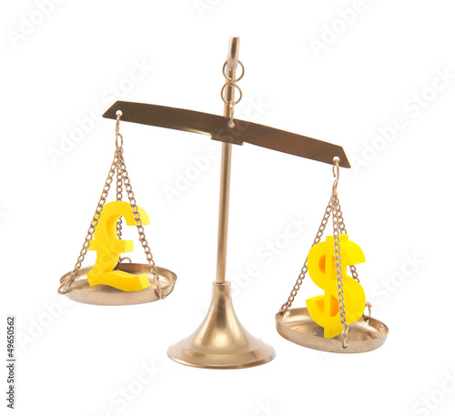 Photo: Pound and Dollar signs on scales isolated on white Pound and Dollar signs on scales isolated on white
