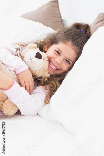 Photo: Little girl cuddling teddy bear Little girl cuddling teddy bear