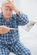 Old man taking his temperature