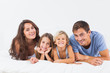 Happy family lying on a bed