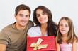 Father and his daughter offering a gift to her mother