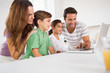 Happy family using a laptop