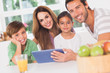 Photo: Happy family using a tablet pc Happy family using a tablet pc