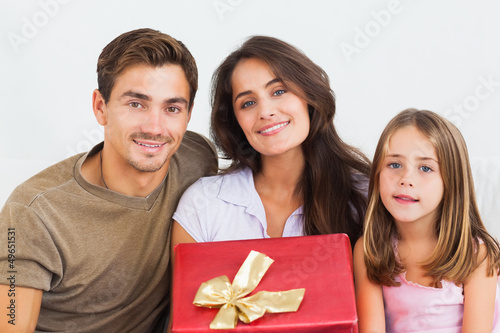 Photo: Father and his daughter offering a gift to her mother Father and his daughter offering a gift to her mother
