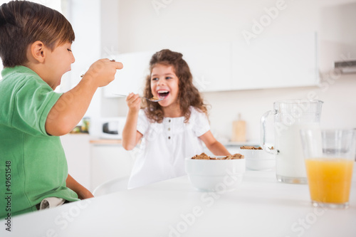 Photo: Two children eating cereal Two children eating cereal