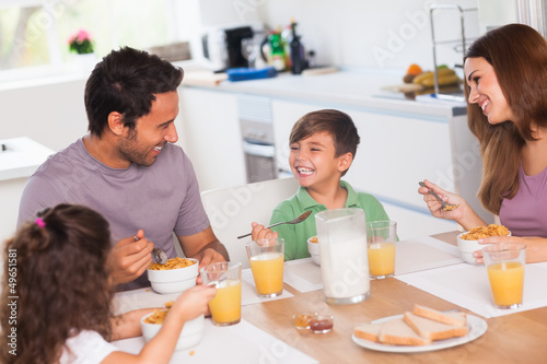 Photo: Family laughing around breakfast Family laughing around breakfast