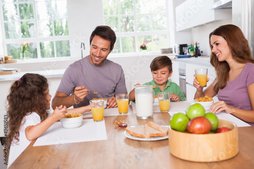 Photo: Family eating healthy breakfast Family eating healthy breakfast