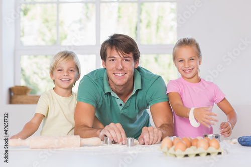 Photo: Smiling family with baking tools Smiling family with baking tools