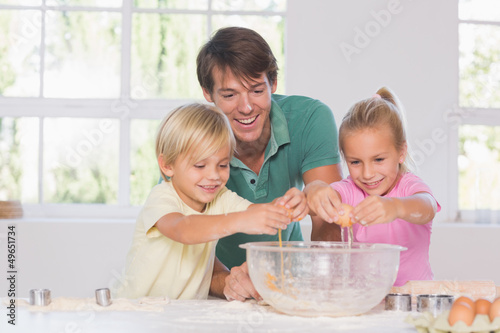 Photo: Children breaking eggs into a bowl Children breaking eggs into a bowl