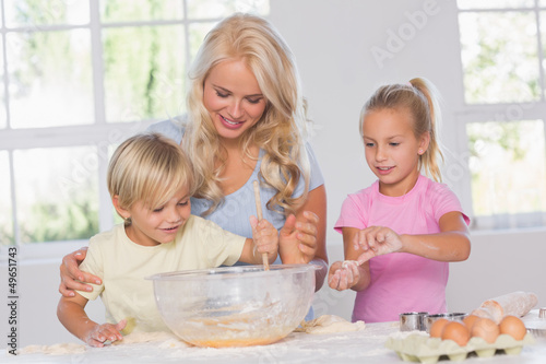 Photo: Children mixing dough with their mother Children mixing dough with their mother