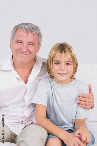 Photo: Portrait of a little boy and his grandfather smiling Portrait of a little boy and his grandfather smiling